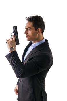 Elegant man with gun, dressed as a spy or secret agent, isolated on white