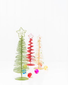 Three colorful stylized christmas trees with ample copy space.