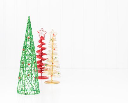 Three colorful stylized christmas trees with ample copy space included.