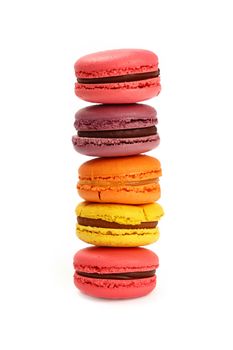 Stack of fresh colorful traditional French macaroon pastry cookies (macarons, macaroni) isolated on white background, close up, low angle view