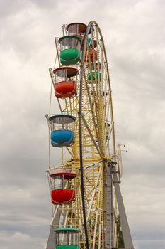 Atraktsion colorful ferris wheel against the sky.