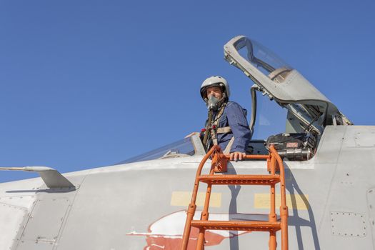 Military pilot in the cockpit of a jet aircraft.