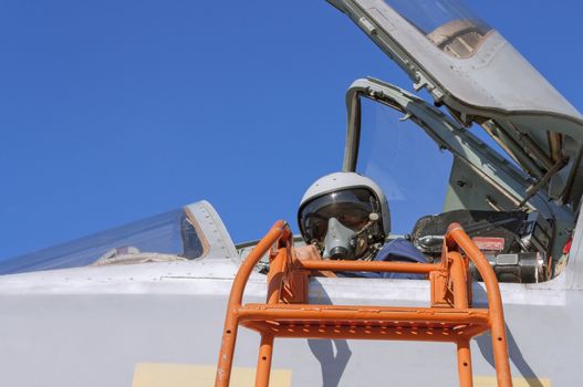 Military pilot in the cockpit of a jet aircraft.