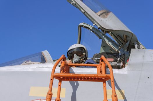 Military pilot in the cockpit of a jet aircraft.