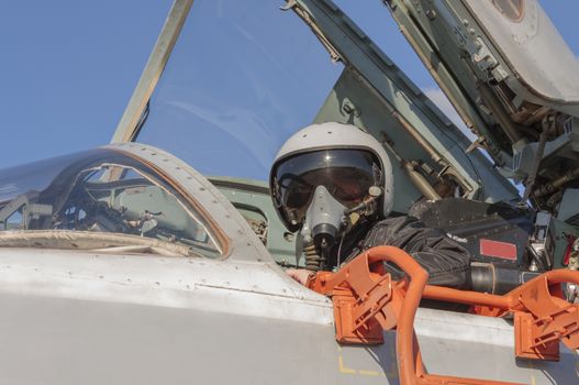 Military pilot in the cockpit of a jet aircraft.