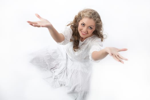 Young smiling beautiful woman on a studio background
