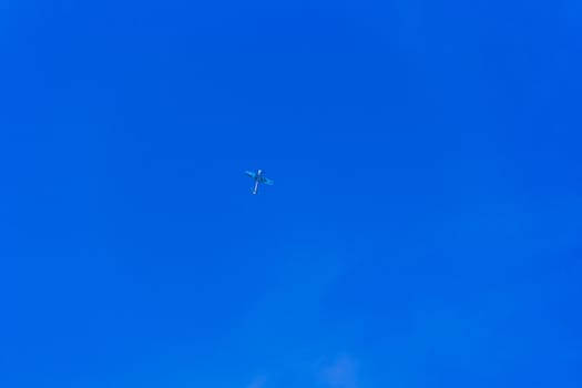 Photo of flying military airplane in blue sky