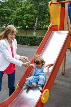 Mother with baby girl riding on hutches with screw up one eyes