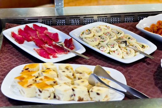 Horizontal photo of meat salad cottage cheese dishes in restaurant with spoon