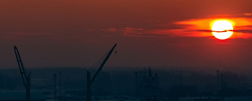 Hot orange sunset over the river. Urban landscape