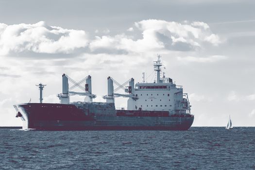 Cargo ship moving entering the port of Riga