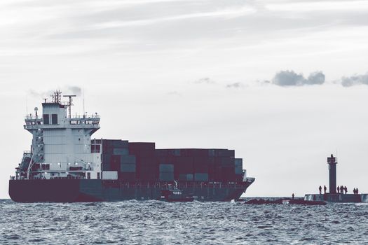 Full container ship leaving Riga and entering Baltic sea