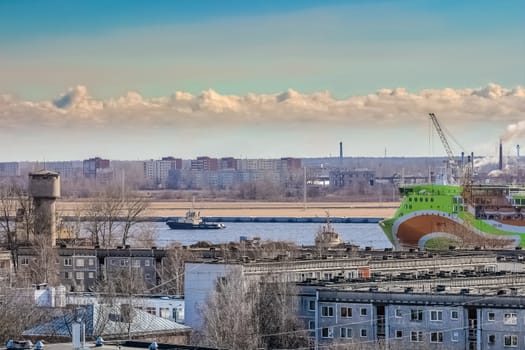 Green cruise liner. Passenger ferry sailing past the Riga city