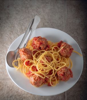 Spaghetti and meat balls with spoon and fork