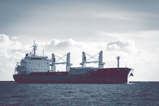 Cargo ship moving entering the port of Riga