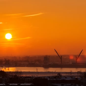 Hot orange sunset over the river. Urban landscape