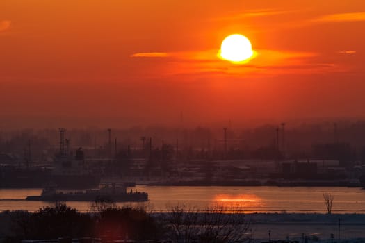 Hot orange sunset over the river. Urban landscape