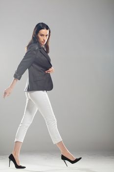 full body shot of beautiful black haired lady walking, motion shot