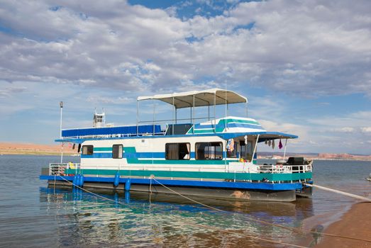 Houseboat on Lake Powell in Southern Utah on a beautiful summer day