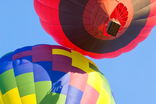 Two hot air balloons bumping each other as they lift off.  This image was taken during the Freedom Festival in Provo Utah that occurs every Fourth of July