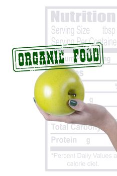 A green apple in a woman's hand, a poster with a stamped seal Organic food