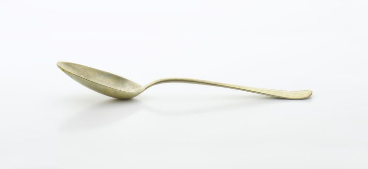 Old silver spoon covered with tarnish