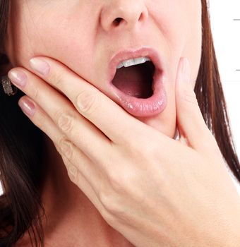 Closeup of woman in strong toothache pain with hands over face. Dental health and care concept. Isolated on white background.