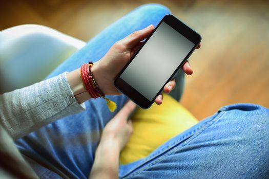 Mobile phone in the hands of a girl with screen