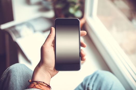 Mobile phone in the hands of a girl with screen