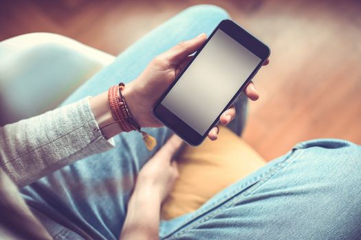 Mobile phone in the hands of a girl with screen