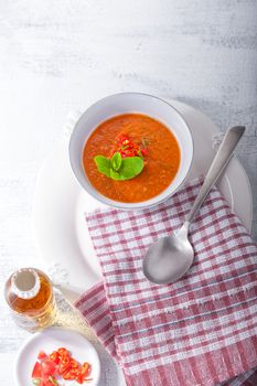 Bowl of fresh tomato soup gazpacho on the table