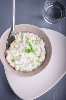 Risotto with Asparagus and cheese served on a table