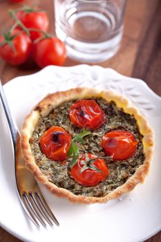 Mini Spinach Quiche with fork on a white plate