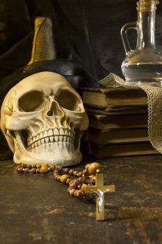 Human skull and ancient books still life