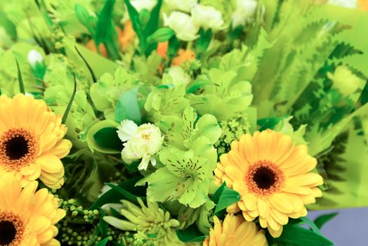 A flower bouquet with a lot of a different flowers