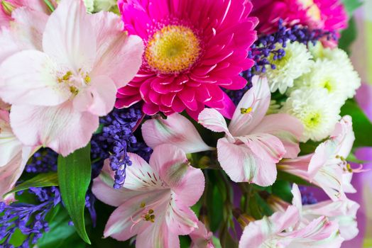 A flower bouquet with a lot of a different flowers