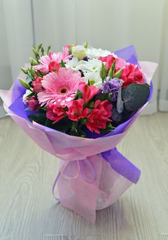 A bouquet of flowers with a gerbera