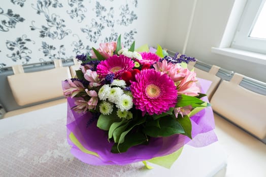 A bouquet of flowers with a gerbera