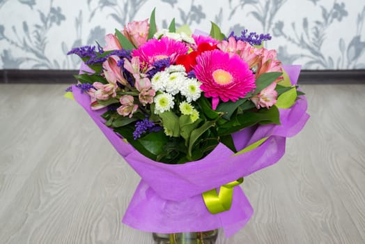 A bouquet of flowers with a gerbera