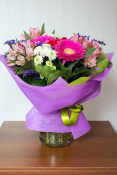 A bouquet of flowers with a gerbera