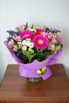 A bouquet of flowers with a gerbera