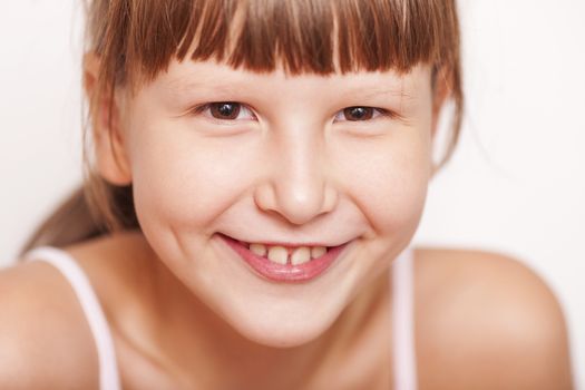 Happy Eight years girl wearing bangs closeup portrait