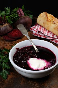 A dish of beet soup with sour cream. Vertical shot.