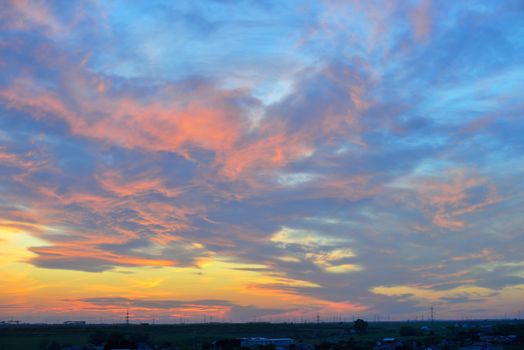 Dramatic sunset over city in spring time