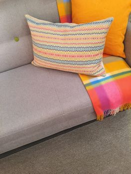 Sofa and cushions in gray and orange tones. Contemporary design.