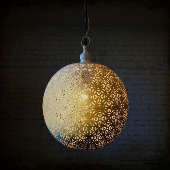 Round decorative metal lamp in a dark room. Modern design.