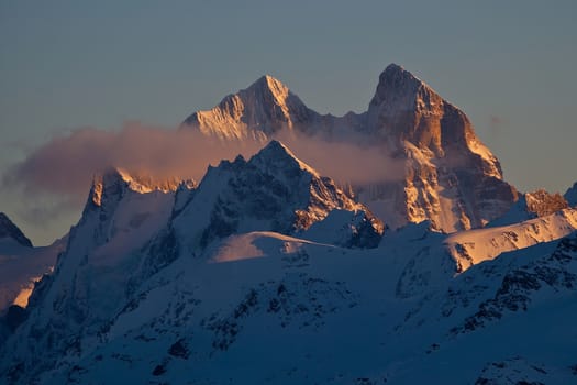 Snow peaks of the mountains in the evening