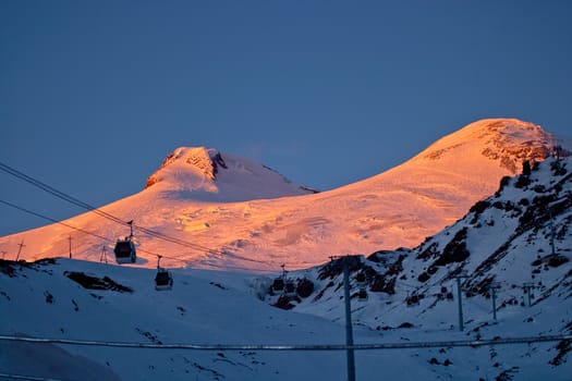 Snow peaks of the mountains in the evening