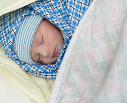 Mixed race south asian and caucasian newborn baby sleeping