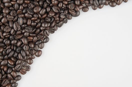 Roasted coffee beans have white space on right use as texture or background.